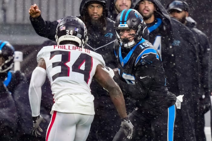 Carolina Panthers wide receiver Adam Thielen (19) runs after a catch as Atlanta Falcons cornerback Clark Phillips III (34) defends during the second quarter at Bank of America Stadium.